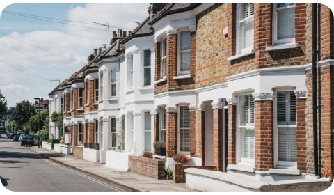 Photo of a street showing the front of traditional UK brick homes.